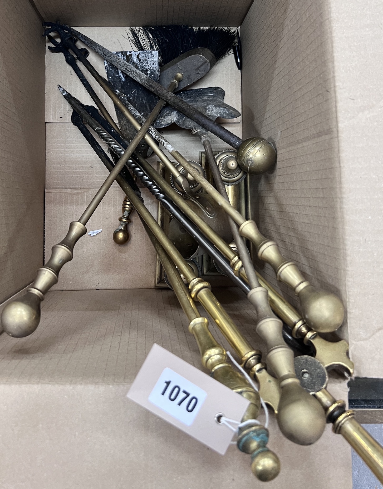 A collection of assorted fire implements and a pair of brass fire dogs